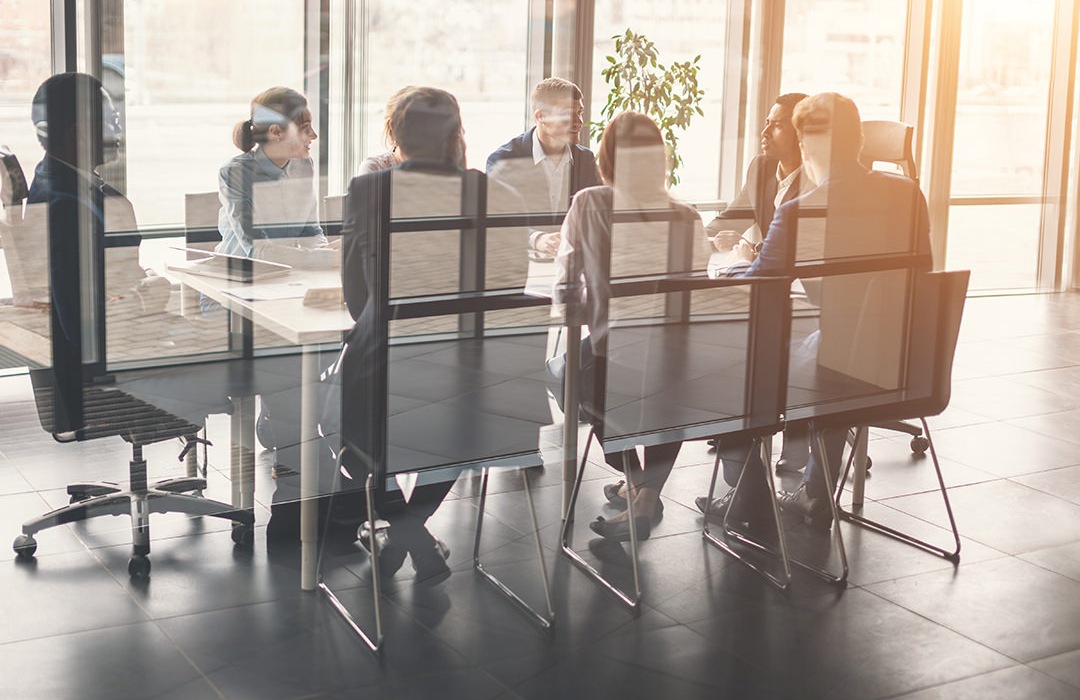 Group of people meeting around a long table 