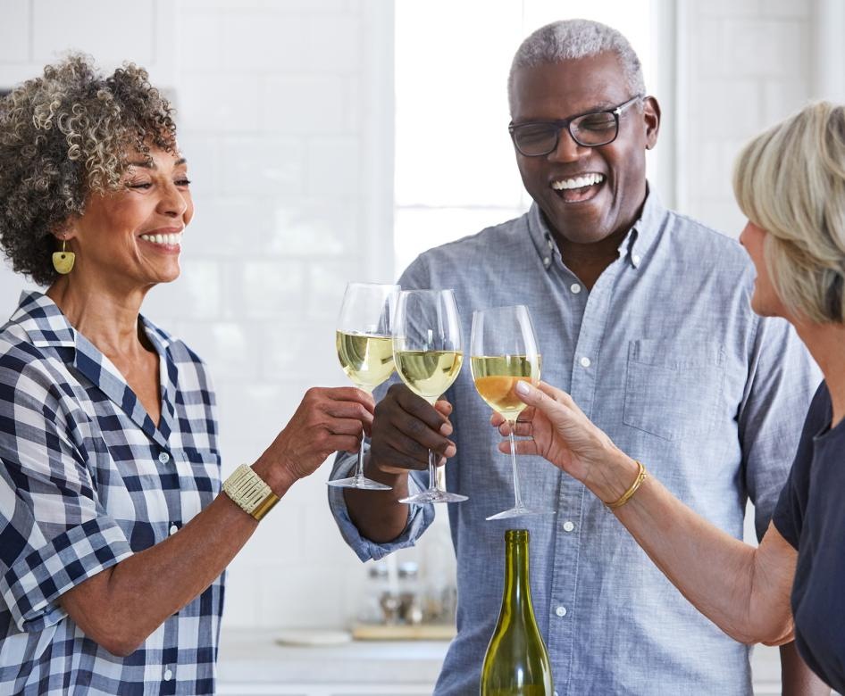 Group of people in a kitchen drinking wine