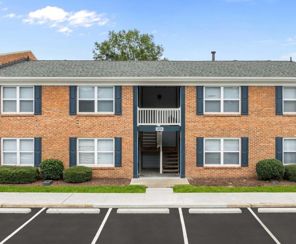 a brick building with a parking lot
