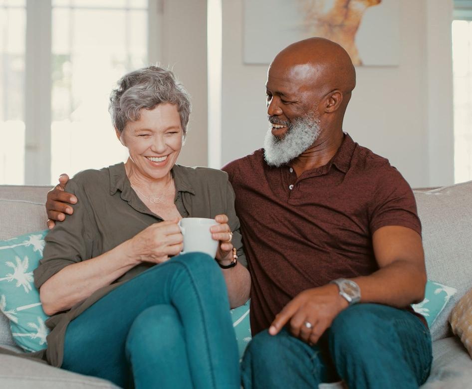 A couple sitting in their well lit living room